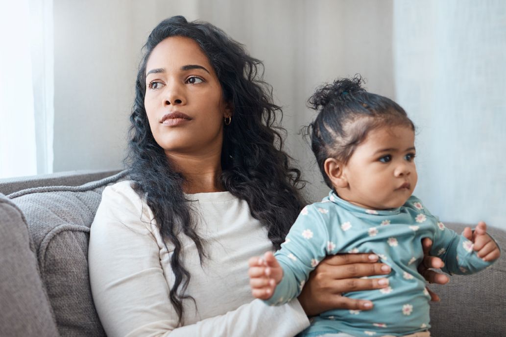 A young Venezuelan woman with Temporary Protected Status (TPS) holding her baby daughter